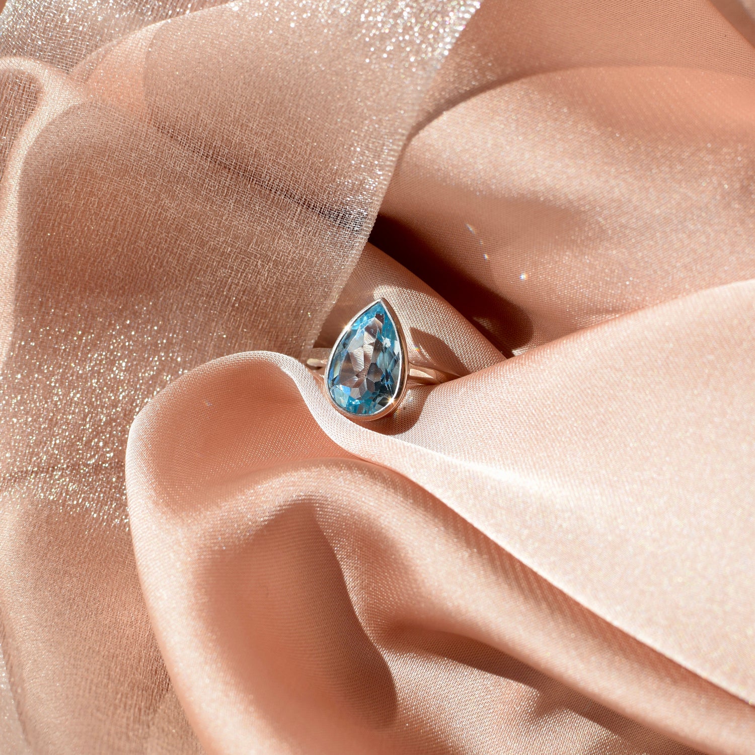 Set in a smooth sterling silver bezel, the gem’s faceted surface reflects every ray with quiet brilliance, creating an effortless harmony between stone and setting.
Blue topaz has long been cherished as a symbol of clarity, communication, and truth. Believed to inspire calm focus and emotional balance, it’s a gemstone that brings both beauty and intention to its wearer.
A timeless piece for everyday elegance or special occasions alike